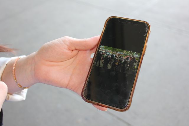 Camila Gini shows a video she took of NYPD officers the night she was arrested at a protest near the Barclays Center in May 2020.